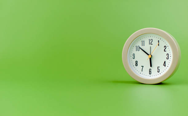 istock alarm clock on green background time concept working with time precious time 1484049216