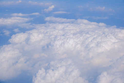 Blue sky background with tiny clouds from airplane nature background