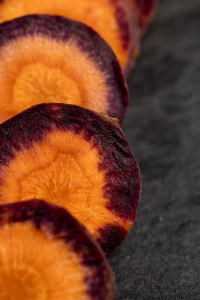 Pieces of sliced peeled carrots are red-orange in color