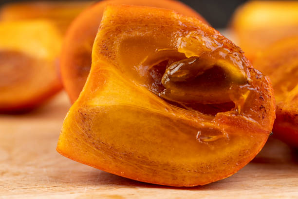 istock slices of sliced persimmon on a cutting board 1484055254
