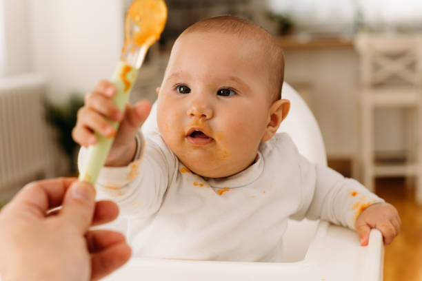 istock Cheerful Baby eating her first meal 1484055515