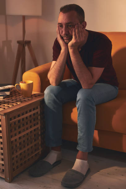 istock Bored man with lethargy and apathy sitting at home alone. 1484057235