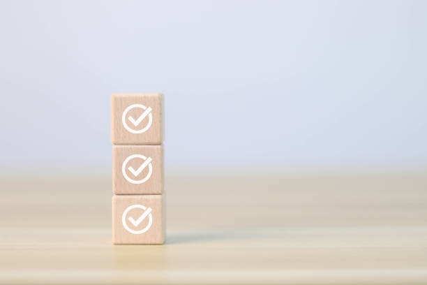 istock Assessment Concept Select the check mark on the wooden block. 1484058576