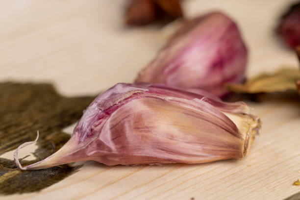 Close-up of garlic bulbs in mesh bags, showcasing fresh, organic produce with a rustic, natural feel, ideal for food, health, or market-related projects.