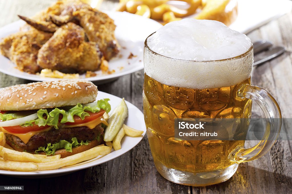 mug of beer mug of beer with hamburger and fries Alcohol - Drink Stock Photo