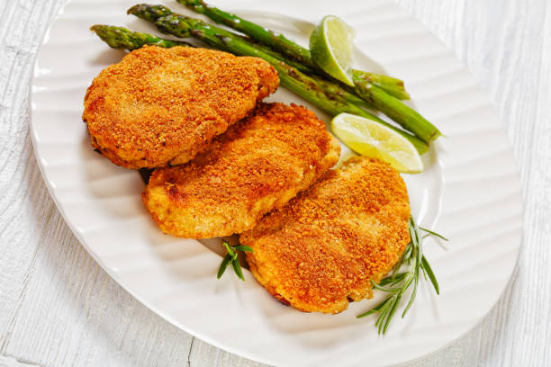 istock breaded chicken breasts with asparagus and lime 1484061473