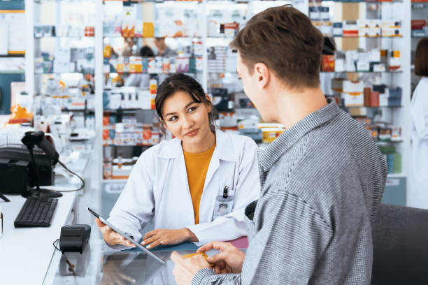 istock Caucasian customer purchases qualified prescription medication from pharmacist. 1484063648