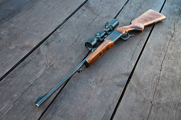 istock Sniper rifle with optical sight on wooden table. 148406826