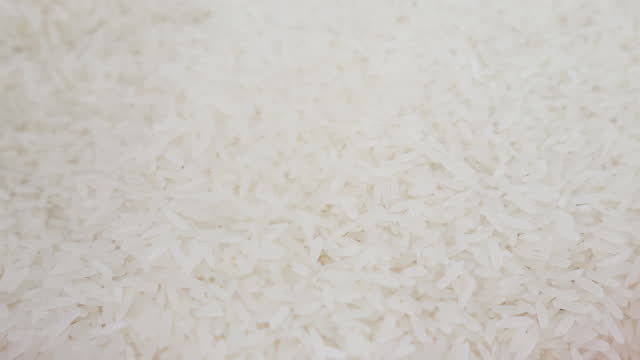 White Rice Grains falls in to pile