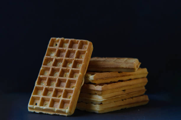 istock Belgian waffles on black stoneplate and black background 1484078044