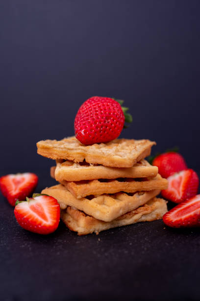 istock Belgian waffles with strawberries on a black background. 1484078502