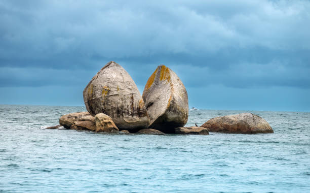 Tokangawha (Split Apple Rock) a geological rock formation in Tasman Bay / Te Tai-o-Aorere off the northern coast of the South Island of New Zealand. Creatceous granite in the shape of an apple cut in half. stock photo