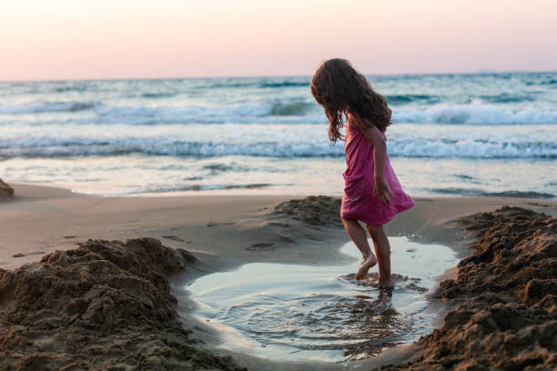 istock Girl playing jumping in the pond 1484085213