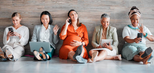 istock Teamwork, technology and diversity with a business team sitting on the floor in their office for work. Collaboration, communication and corporate design with a woman employee group working together 1484091667