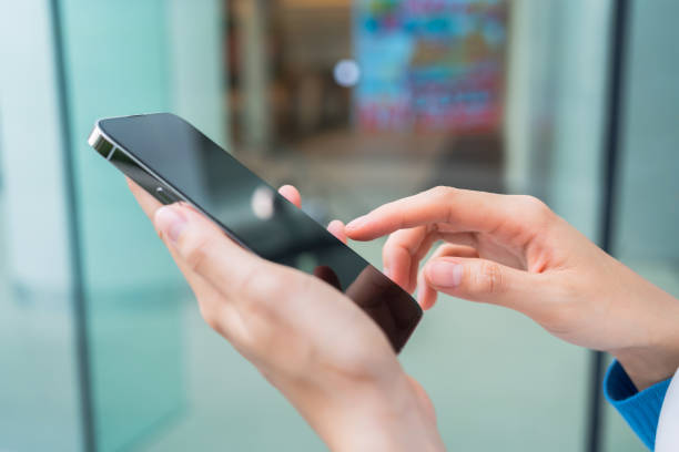 istock Hands using smartphone in public areas, During leisure time. The concept of using the phone is essential in everyday life. 1484095135