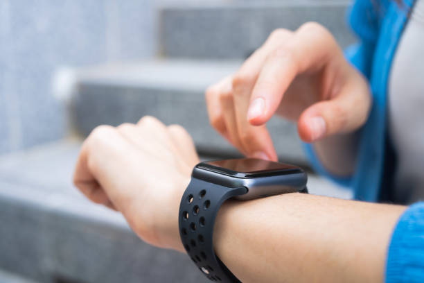 istock Woman wearing a smartwatch and touching to check on o'clock. 1484095511
