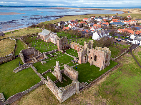 Aerial view of the medieval ruins of Lindisfarne Priory on Holy Island off the coast of Northumberland in northeast England.