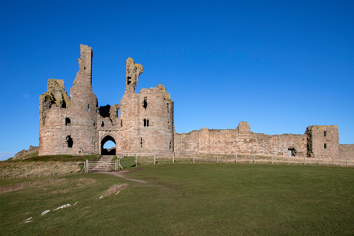 The 14th-century fortiress of Dunstanburgh Castle on the coast of Northumberland in northeast England