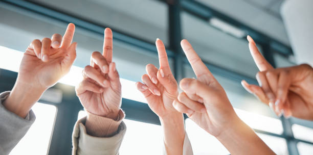 istock Hands up, fingers and group in office for answer, brainstorming or ideas for corporate development. Team building, business people and workshop with question, solution or teamwork for strategy at job 1484097986