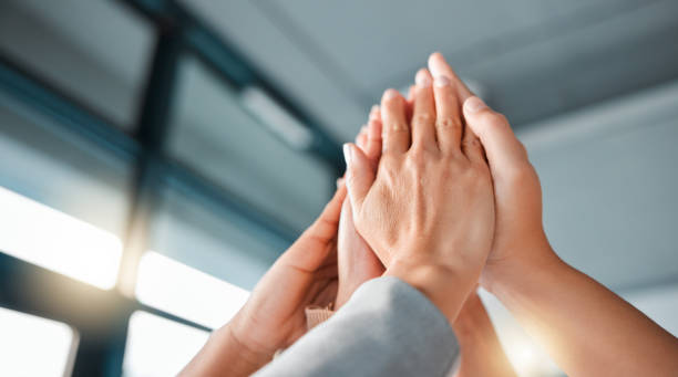 istock Hands, team and high five for collaboration, trust or unity in coordination or corporate goals at the office. Hands of group in teamwork celebration for partnership, agreement or community support 1484097987