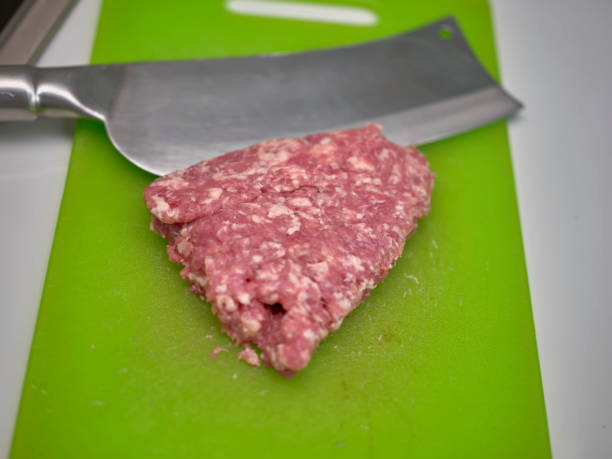 istock Raw uncooked Minced meat on green chopping board . 1484098952