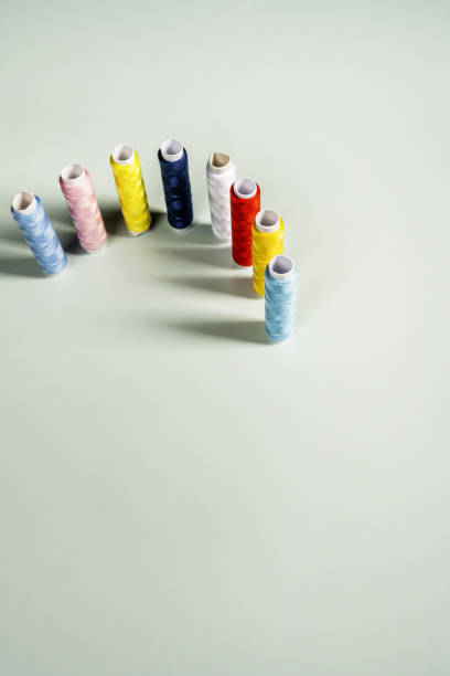 istock spools of unused sewing thread of various colors on a light plain background 1484100043