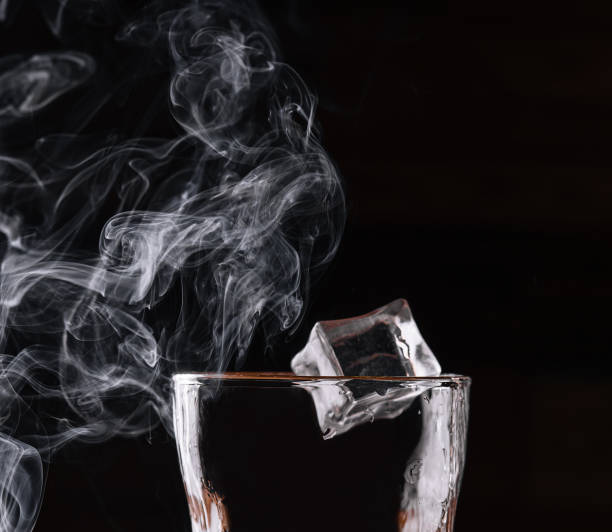 istock Glass of whiskey with ice on black 1484102331