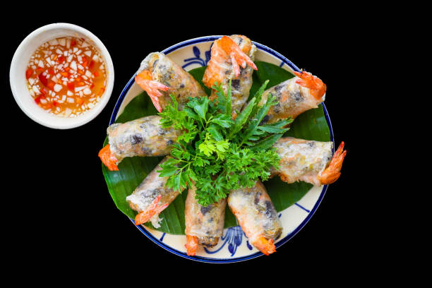 istock Traditional fried vietnamese spring rolls with shrimps and pork, rice paper on black background 1484108949