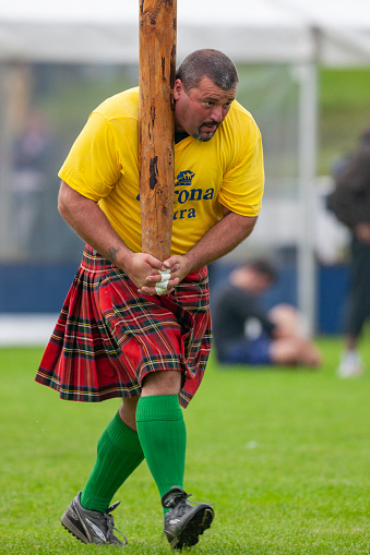 Tossing the Caber at the Cowal Gathering. A traditional Highland Games held each year in Dunoon in Scotland
