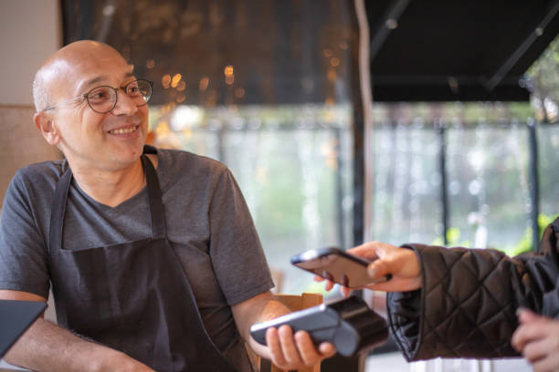 istock Middle-aged man receives payment from customer. 1484117593