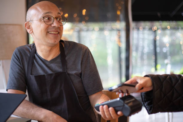 istock Middle-aged man receives payment from customer. 1484117983