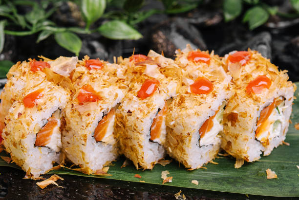 istock Closeup of sushi rolls on black plate 1484122108