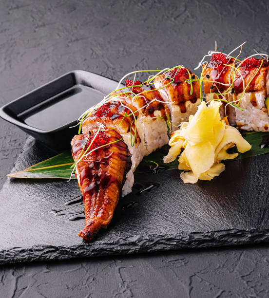 istock Canadian roll with eel, cheese cream and avocado on black 1484122230