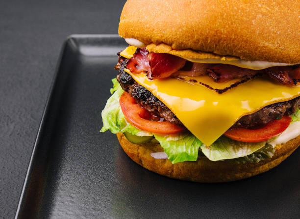 istock Bacon burger with beef patty on black tray 1484122408