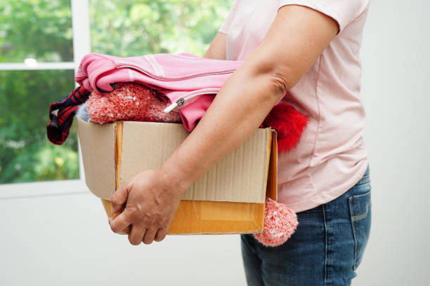 istock Clothes donations in cardboard box for volunteer. 1484124882
