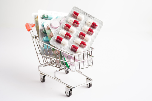Shopping trolley with blister pill and capsule from drug prescription, pharmacy for treatment health medicine.