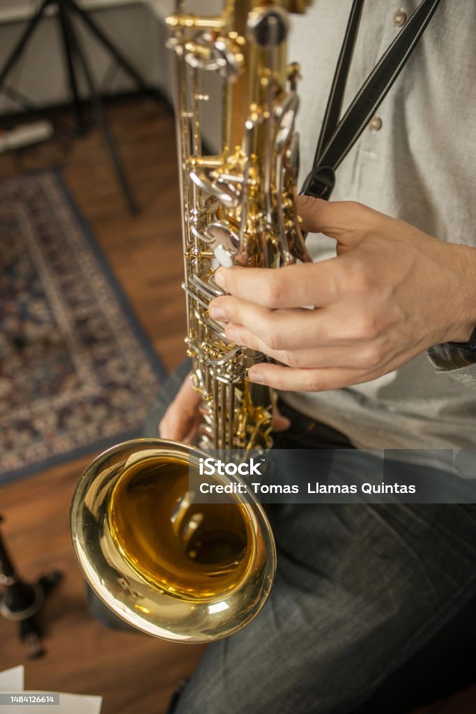 Hands of a musician playing the saxophone in a rehearsal room Abstract Stock Photo