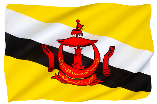 Flag of Brunei - In Southeast Asia, yellow is traditionally the color of royalty. The crescent symbolizes Islam, the parasol symbolizes monarchy, and the hands at the side symbolize the benevolence of the government. Adopted 29th September 1959. Isolated on white for cut out.