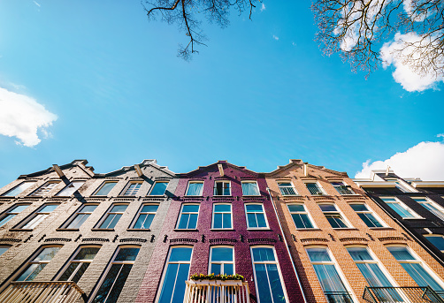 Typical Amsterdam houses and blue sky in Springtime afternoon