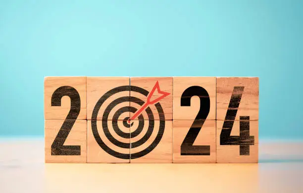 2024 year with dartboard and arrow on wooden block cube for setup new business objective target and goal  since new year concept , Happy new year and merry Christmas concept.