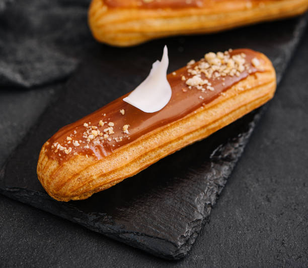 Traditional french dessert. eclair with caramel stock photo