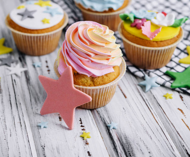 istock Multiple colorful nicely decorated muffins on a wooden background 1484130091