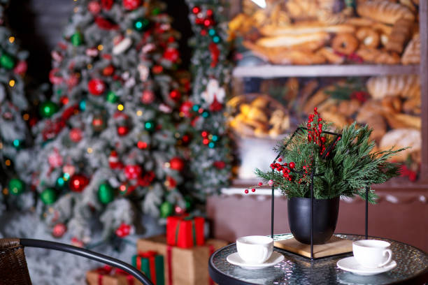 istock A table for two, two chairs with blankets against the backdrop of a bakery in New Year's decorations 1484130472