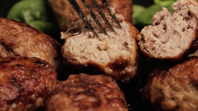 Pork, beef or chicken minced meat cutlets. The cook shows how juicy the cutlets are. Pan-fried meatballs.