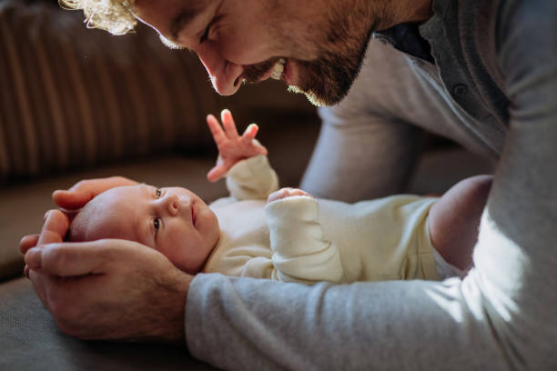 Close-up of father cudddling his little son. Close-up of father cuddling his little new born baby. father holding son stock pictures, royalty-free photos & images