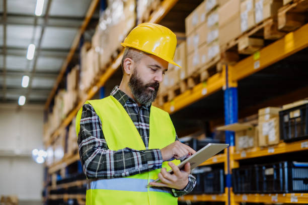 istock Portrait of a warehouse worker or supervisor with digital tablet. 1484138308