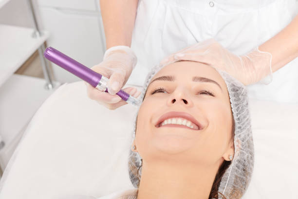 Beautician makes mesotherapy injection for rejuvenation woman face, procedure in beauty salon stock photo