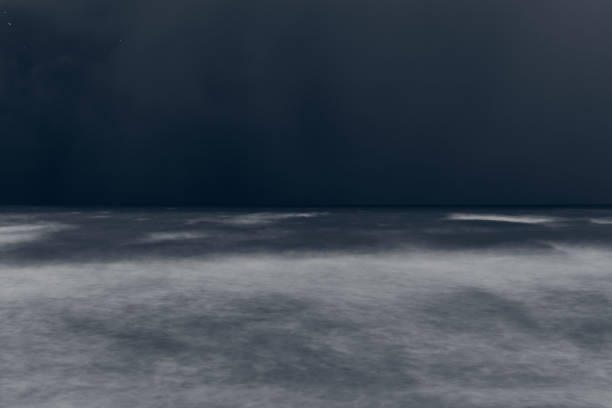 istock Blurred defocused blue sea waves at deep night, beautiful blurred storm tide seascape on blue dusk 1484139721