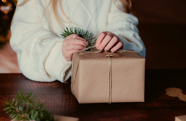 istock Girl decorating Christmas gifts. 1484140055