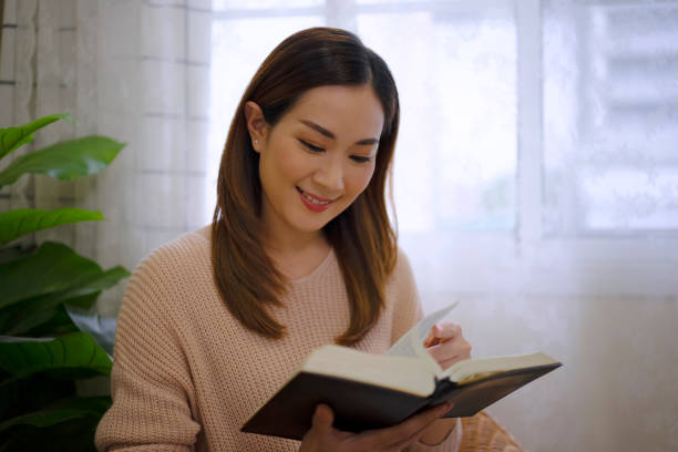 istock Woman is reading and writing a book at home. 1484140993